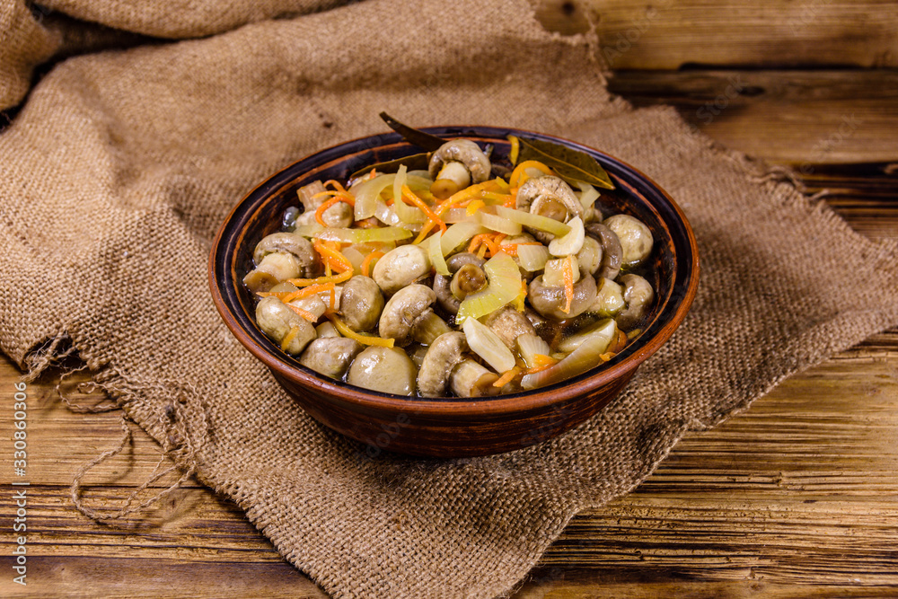 Canned mushrooms with carrot and onion in a ceramic bowl Canned mushrooms with carrot and onion in a ceramic bowl