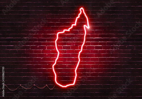 Neon sign on a brick wall in the shape of Madagascar.(illustration series)