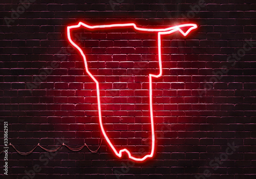 Neon sign on a brick wall in the shape of Namibia.(illustration series)