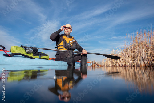senior male with stand up paddleboard