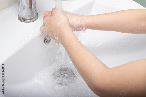 The child washes his hands with soap. Virus Prevention Coronavirus protection.