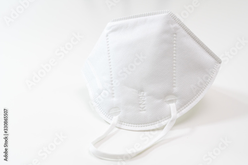 One KN-95 protection medical mask isolated on white background. Prevention of the spread of virus and epidemic, protective mouth filter mask. Diseases, flu, air pollution, corona virus concept