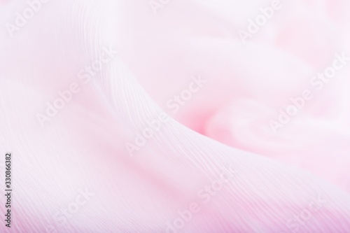 Pale pink corrugated flowing silk fabric background