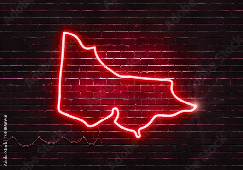 Neon sign on a brick wall in the shape of Victoria.(illustration series)