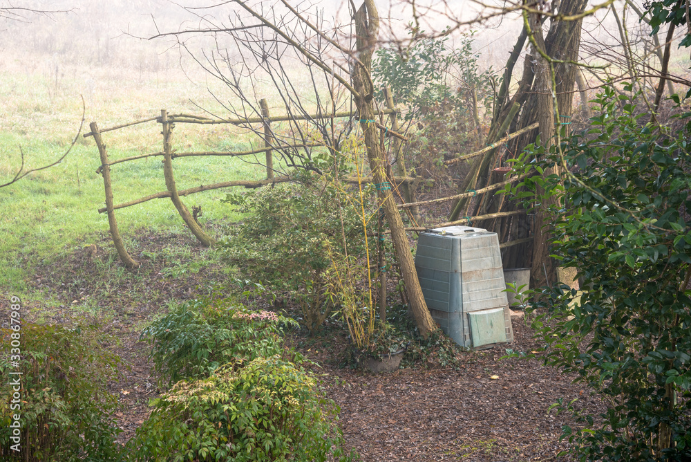 Compost bin in a backyard of a farmhouse on a misty winter morning Compost bin in a backyard of a farmhouse on a misty winter morning