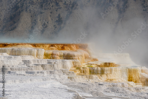 A steaming pool of thermal water has over time created colorful and unique terraces.