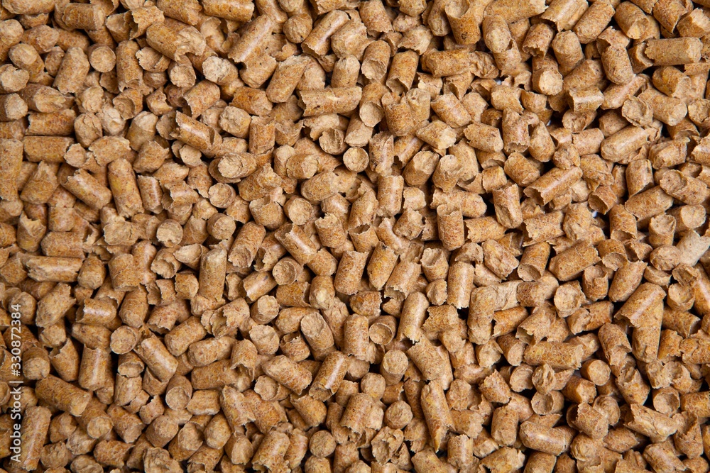 Wooden pellets. Alternative heating in winter. Texture of house pellets for heating. Ecologically energy. Wood background. Wooden pellets. Alternative heating in winter. Texture of house pellets for heating. Ecologically energy. Wood background.