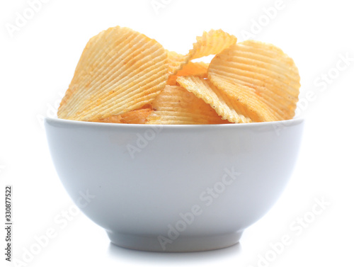 Fotografie Potato chips on bowl isolated on white