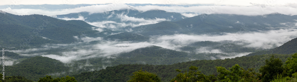 Panoramic view of the Smoky mountains in North Carolina with clouds on the ridges Panoramic view of the Smoky mountains in North Carolina with clouds on the ridges