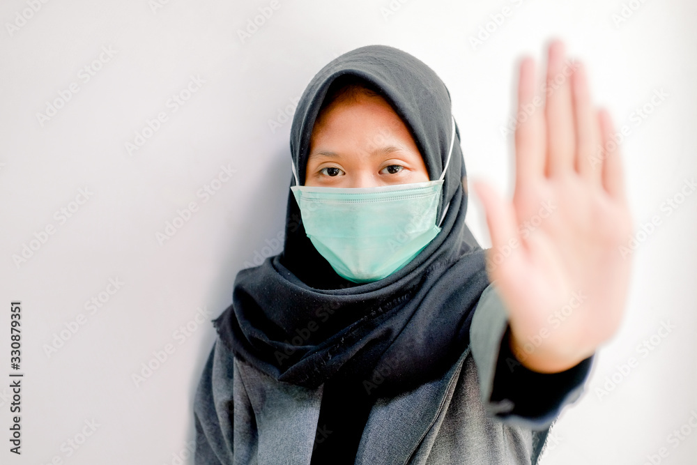 Coronavirus and Air pollution concept. portrait of young asian girl wearing mask for protect covid-19 and show stop hands gesture for stop corona virus outbreak. Coronavirus and epidemic virus sympto Coronavirus and Air pollution concept. portrait of young asian girl wearing mask for protect covid-19 and show stop hands gesture for stop corona virus outbreak. Coronavirus and epidemic virus sympto