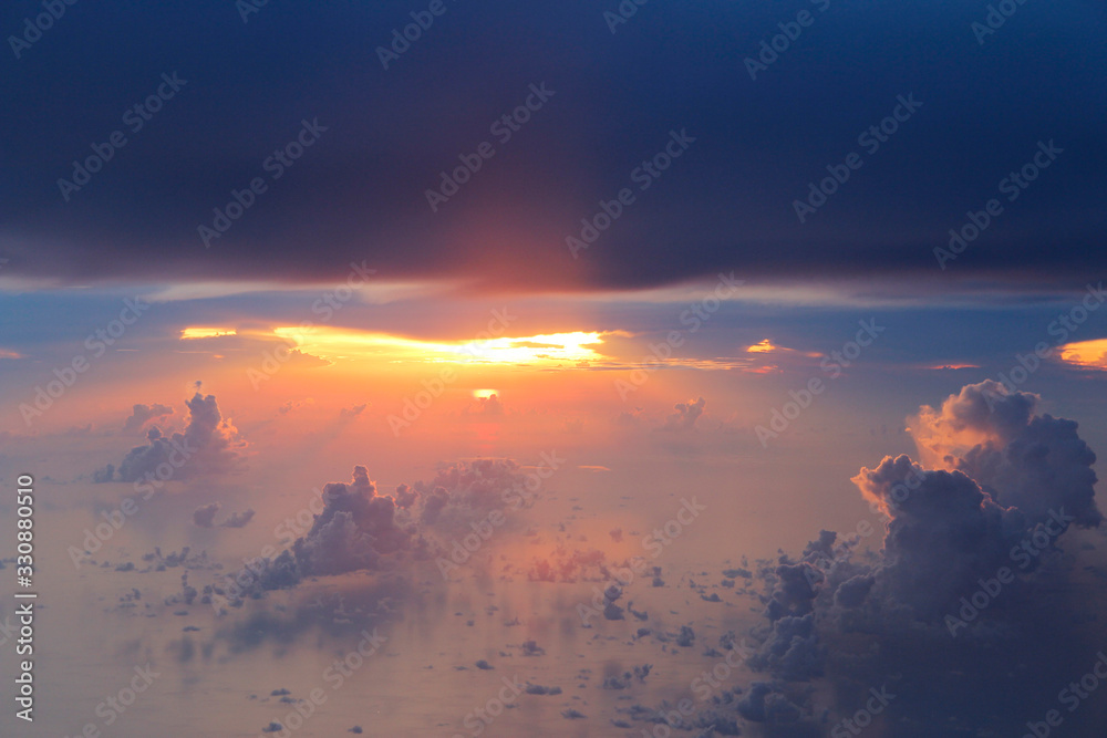 Dramatic cloudscape during sunset from the airplane's window