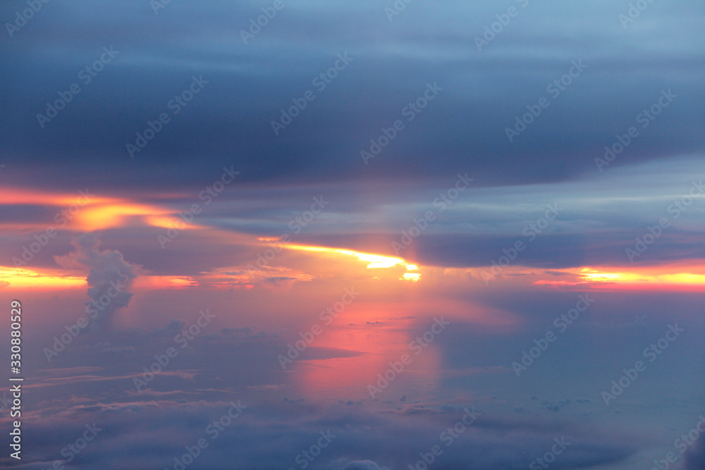 Dramatic cloudscape during sunset from the airplane's window