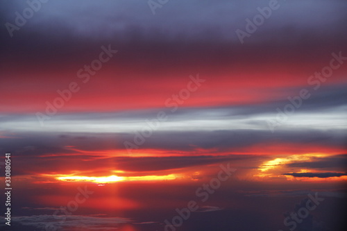 Dramatic cloudscape during sunset from the airplane's window © Crystaltmc