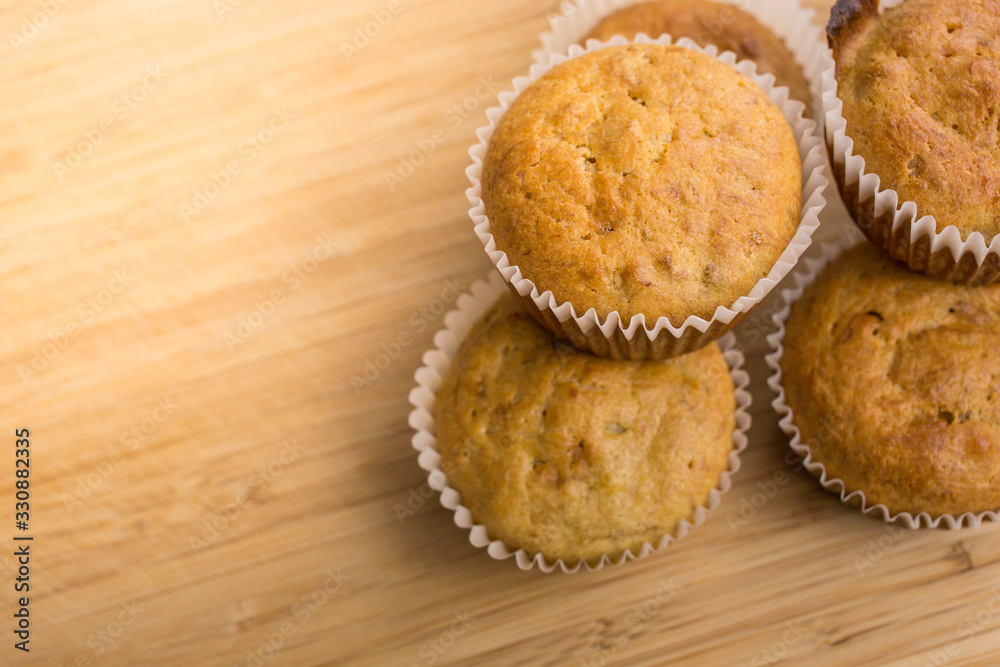 Homemade fresh baked Muffins on a wood table in a baking parchment paper. Homemade fresh baked Muffins on a wood table in a baking parchment paper.