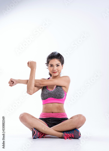 The beauty lady wearing sportwear sitting on ground floor, stretching body,prepare for exercise © Watcharin