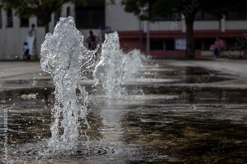 Small thick water jets of a park fountain in the town of Knjazevac  eastern Serbia. Fast shutter  water splash  close up.