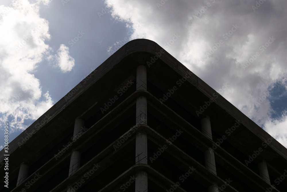 Low angle photo of construction building against cloudy sky