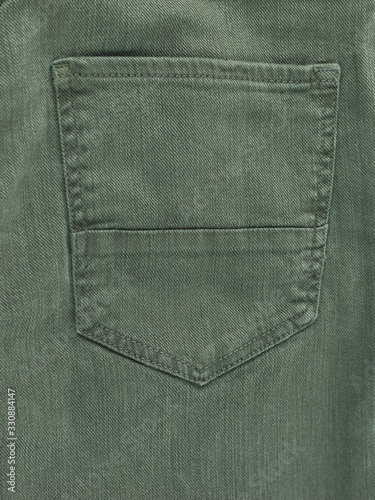 Background of green jeans with a pocket.