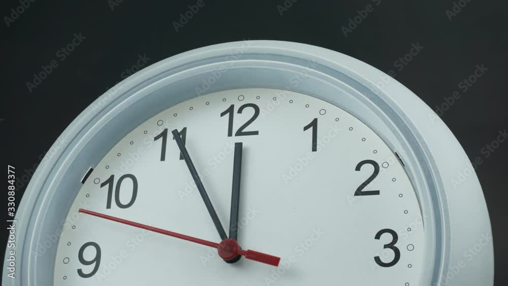White wall clock show time Twelve o'clock on black background, Time lapse moving fast, Time concept. White wall clock show time Twelve o'clock on black background, Time lapse moving fast, Time concept.