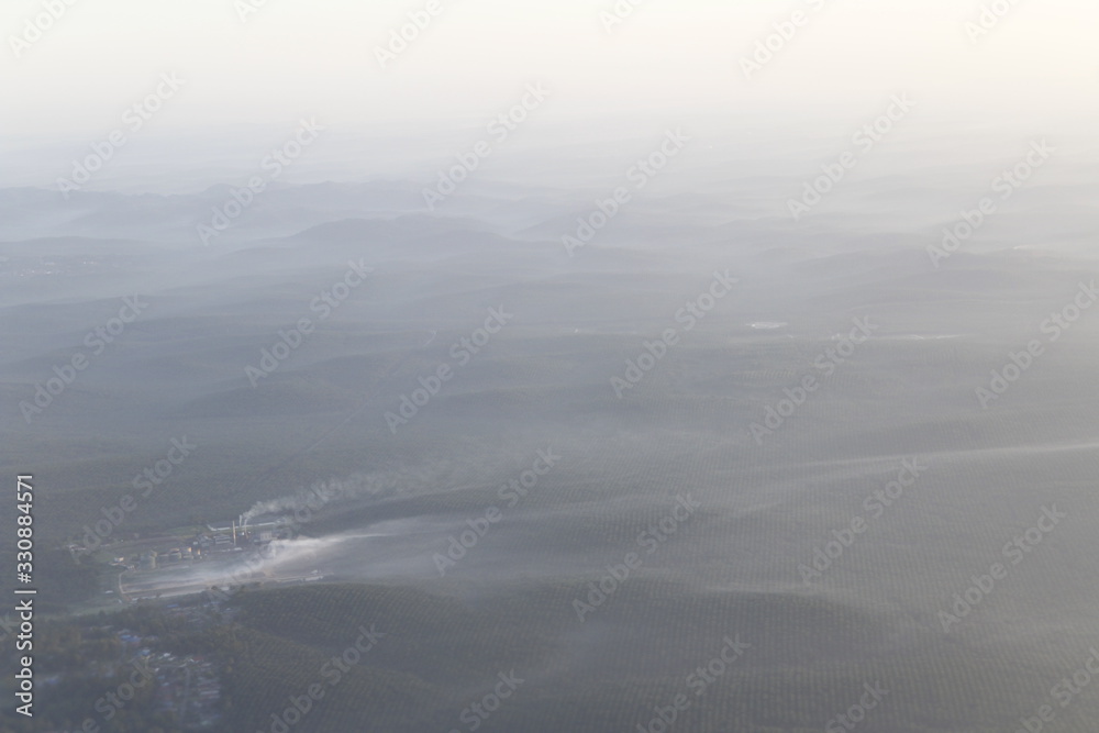 Obraz premium Beautiful landscape during sunrise from the airplane's window