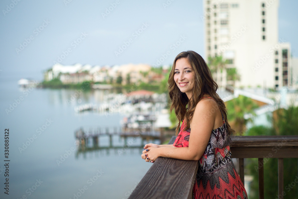 Young woman overlooking city from balcony