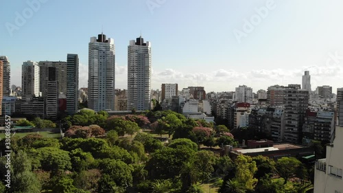 Aerial panoramic view of Las Heras Park in Palermo, Buenos Aires. Drone flying forward with a blue sky as background photo