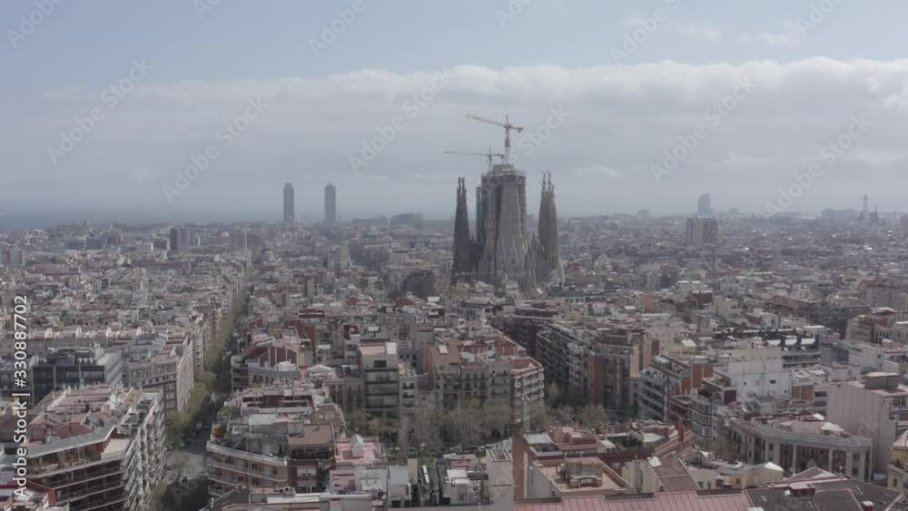 aerial image with right pan of barcelona with sagrada familia church quarantined by corona virus aerial image with right pan of barcelona with sagrada familia church quarantined by corona virus