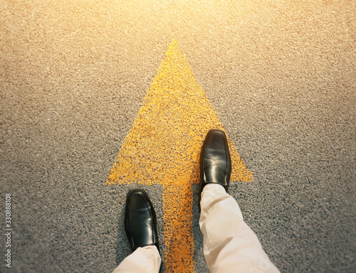 Feet and arrows on road.