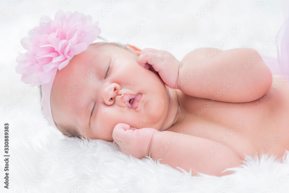 Cute newborn baby lies swaddled in a white blanket. Close up view. Cute newborn baby lies swaddled in a white blanket. Close up view.