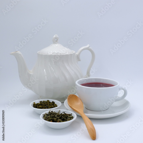 Top view mockup a cup of tea and tea leaf on the white desk. Free space for your text.
