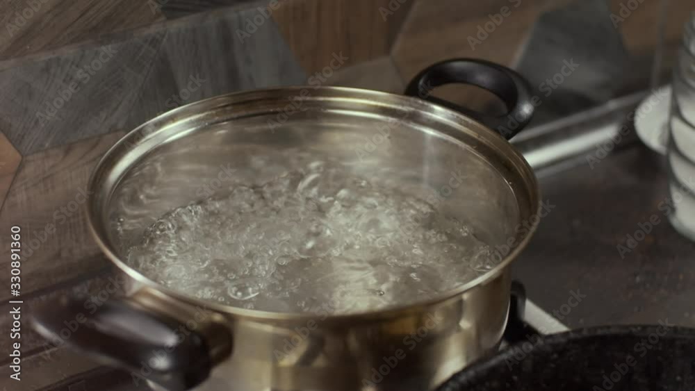 Boiling water in pan, slow motion, shallow depth of field Boiling water in pan, slow motion, shallow depth of field