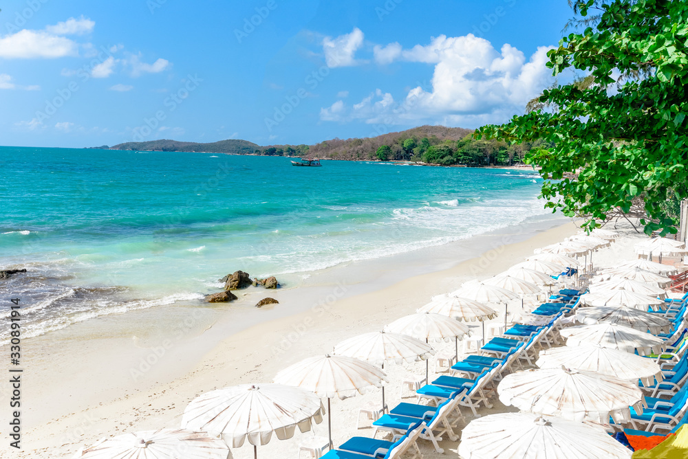 Fototapeta premium Sea waves on sand beach water and coast seascape - View of beautiful tropical landscape beach sea island with ocean blue sky and resort background in Thailand vacation with chair beach summer and tree