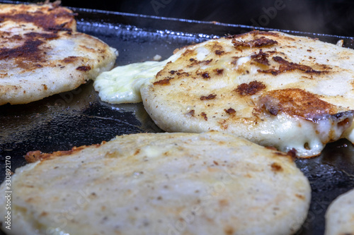 pupusas from El Salvador, a typical delicious native dish made with corn dough, fill with cheese, beans and or pork rind photo
