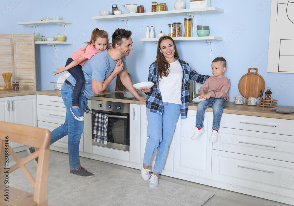 Young family washing dishes in kitchen Young family washing dishes in kitchen