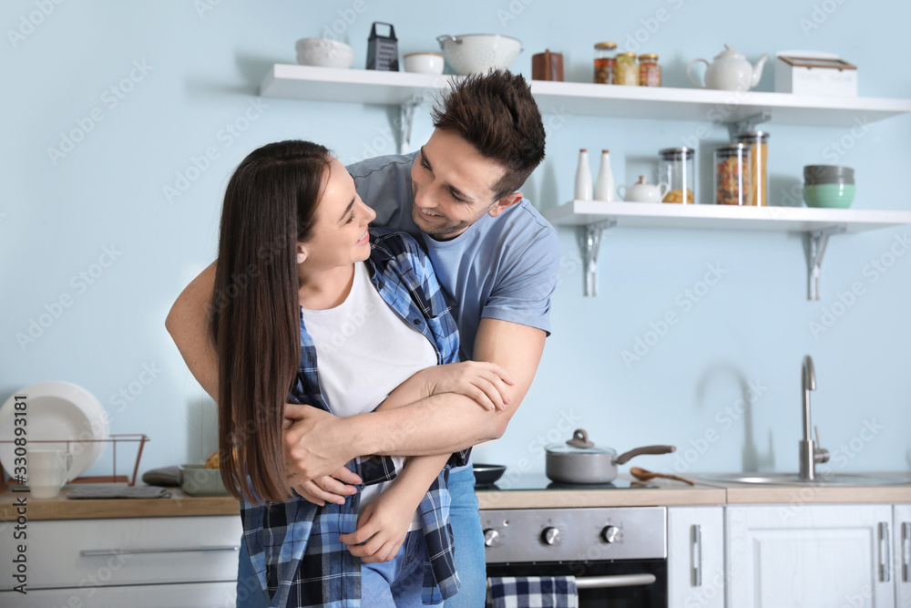 Happy young couple in kitchen