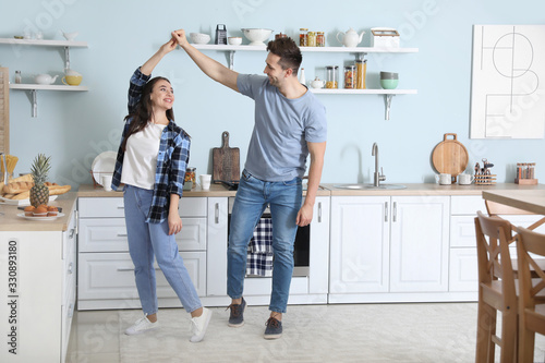 Young couple dancing in kitchen