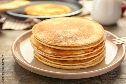 Stack of tasty pancakes on plate