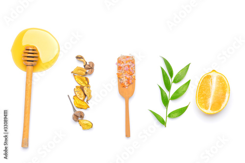Composition with honey, sea salt and lemon on white background