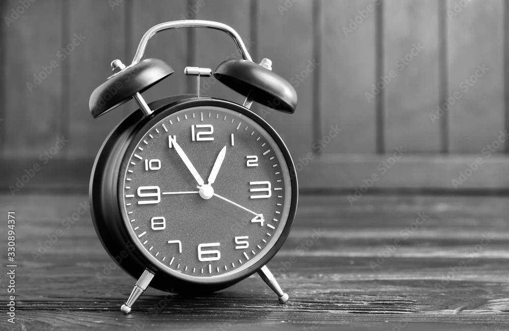 Alarm clock on dark wooden background. Time management concept Alarm clock on dark wooden background. Time management concept