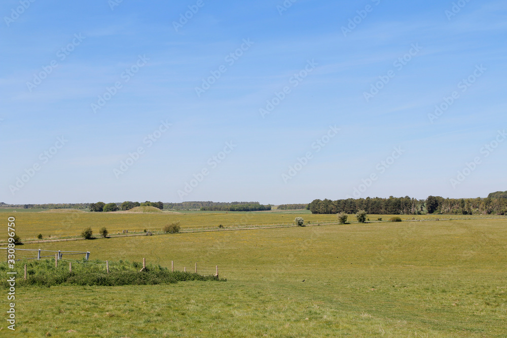 Landscape of Spring with the green meadow and blue sky on a sunny day near the Stonehenge, United Kingdom