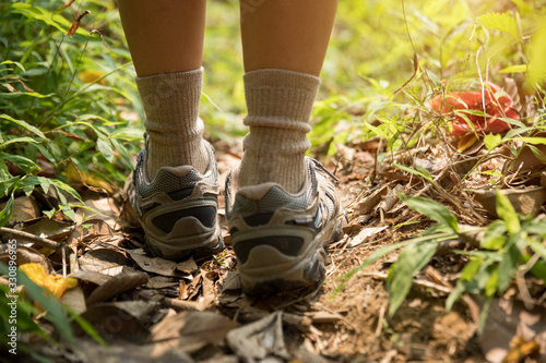Young woman hiker legs walking on trail in spring mountains