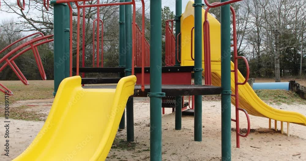 Colorful playground equipment abandoned in a vacant park Colorful playground equipment abandoned in a vacant park
