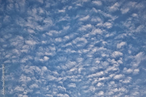 Cirrocumulus cloud formations in the sky during the evening just before Springtime in Houston, TX. High altitude clouds that can signify several things, including the onset of rain. photo