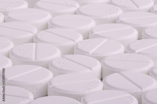 Lots of pills. Macro photography of pills. White round medicine pills close up.