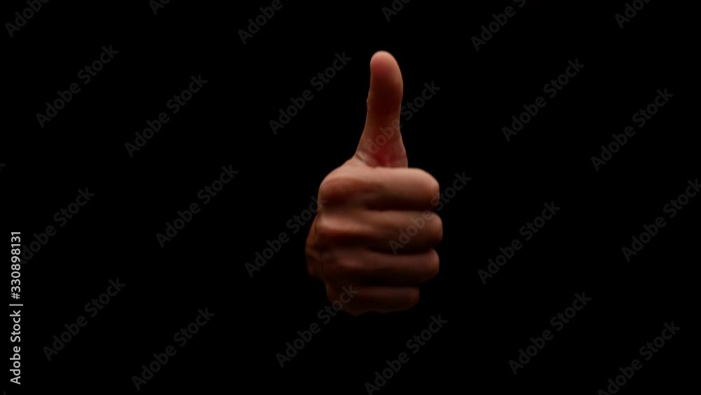 Male hand showing gesture isolated on black background Male hand showing gesture isolated on black background