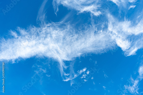Cirrus is cloud stripe, white, feathery, ice crystal. Blue background of the sky. © woff