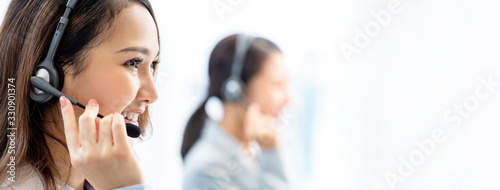 Banner of smiling telemarketing Asian woman working in call center office