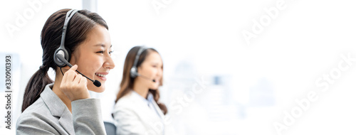 Banner of smiling telemarketing Asian woman working in call center office photo