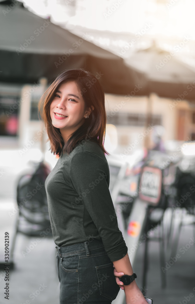 Portrait of Smart Asian Woman Smiling in Front of Coffee Shop at Co-Working Space in Shopping Center on Business District Location - Happy Emotion Relax Concept (Vintage Film Tone) Portrait of Smart Asian Woman Smiling in Front of Coffee Shop at Co-Working Space in Shopping Center on Business District Location - Happy Emotion Relax Concept (Vintage Film Tone)