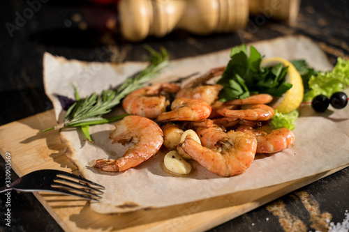 boiled king prawns, restaurant serving, large prawns, prawns serving on a wooden board photo